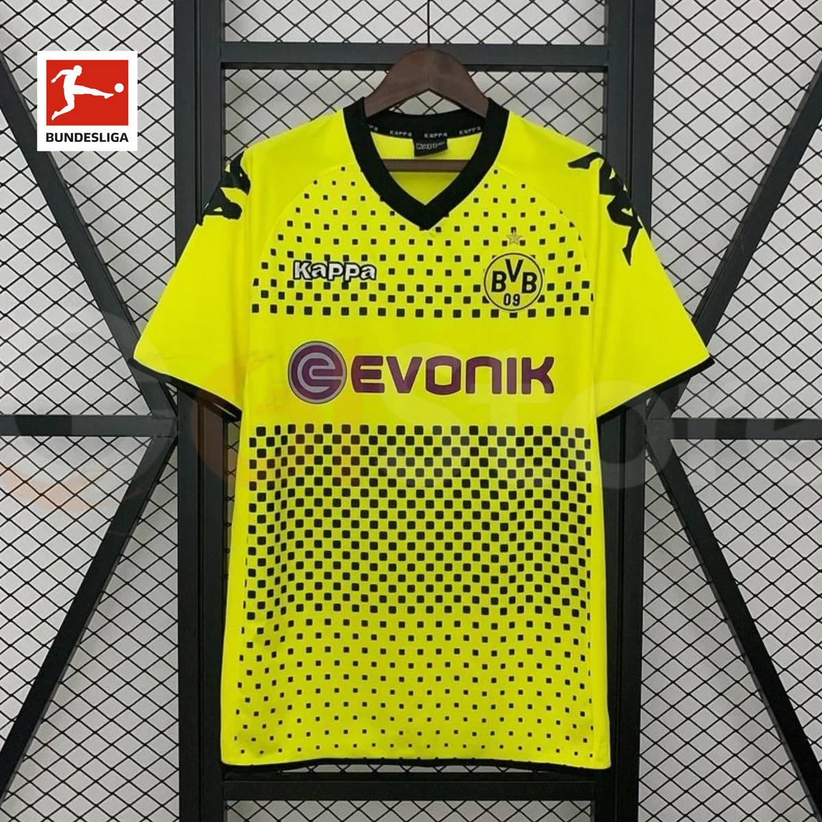 Features a yellow body with a black square pattern, a black V-neck, shoulder logos, the BVB 09 crest and contrasting Evonik sponsor detailing.

