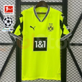 Borussia Dortmund neon yellow-green jersey with black patterned short sleeves, patterned V-neck and 1&1 sponsor, alongside Bundesliga and UCL graphics.
