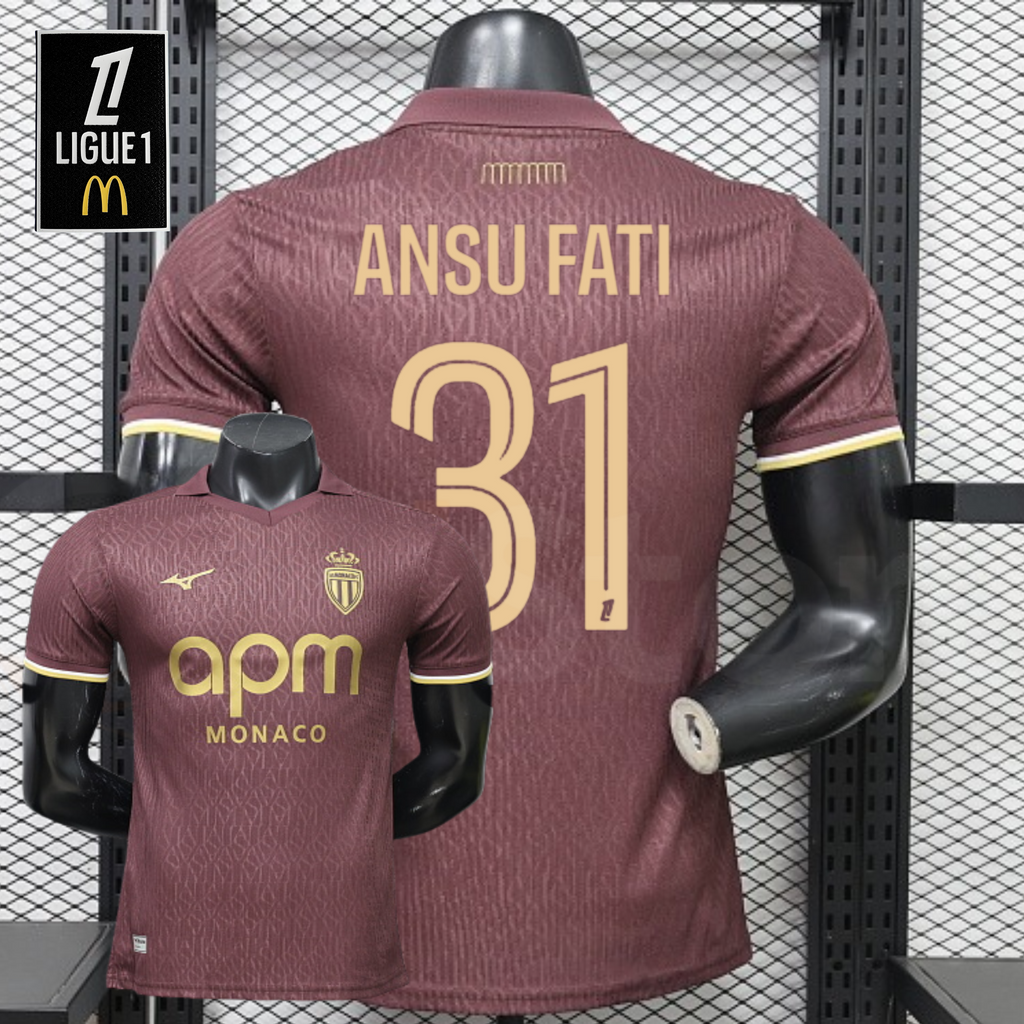 AS Monaco burgundy short-sleeve jersey shown from the front and back, with gold ANSU FATI 31 print, tonal pattern and APM Monaco sponsor, alongside a Ligue 1 graphic.
