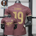 AS Monaco burgundy short-sleeve jersey, front and back views with gold CABRAL 19 print, tonal pattern and APM Monaco sponsor, alongside Europa League graphics.
