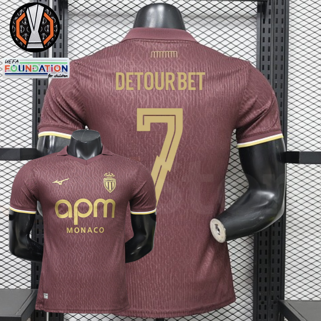 AS Monaco burgundy short-sleeve jersey, front and back views with gold DETOURBET 7 print, tonal pattern and APM Monaco sponsor, alongside Europa League graphics.
