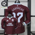 Front and back views of a claret Aston Villa long-sleeve jersey with a light blue collar, light blue Garnacho number 17 print and Visit Rwanda sponsor.