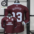 Front and back views of a claret Aston Villa long-sleeve jersey with a light blue collar, light blue Ruggeri number 13 print and Visit Rwanda sponsor.