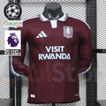 Front view of a claret Aston Villa long-sleeve jersey with a light blue collar, white shoulder stripes, club crest and Visit Rwanda sponsor.