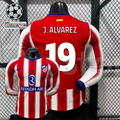 Front and back views of a red and white Atlético Madrid long-sleeve jersey with blue trim, white J. Alvarez number 19 print and Riyadh Air sponsor, alongside UCL graphics.