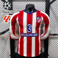 Front view of a red and white striped Atlético Madrid long-sleeve jersey with blue neckline details, club crest and Riyadh Air sponsor, alongside UCL and LaLiga graphics.