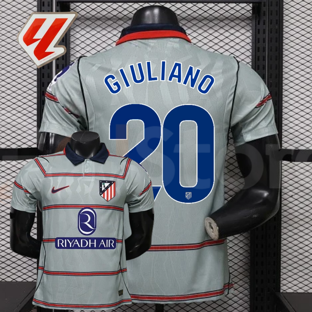 Front and back views of a light grey Atlético Madrid short-sleeve jersey with red horizontal stripes, blue Giuliano number 20 print and Riyadh Air sponsor, alongside a LaLiga graphic.