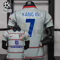 Front and back views of a light grey Atlético Madrid short-sleeve jersey with red horizontal stripes, blue Kang In number 7 print and Riyadh Air sponsor, alongside UCL graphics.