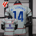 Front and back views of a light grey Atlético Madrid short-sleeve jersey with red horizontal stripes, blue M. Llorente number 14 print and Riyadh Air sponsor, alongside a LaLiga graphic.