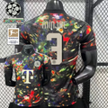 Front and back views of a black Bayern Munich short-sleeve jersey with a multicolored abstract design, cream Minjae number 3 print and Telekom sponsor, alongside UCL and Bundesliga graphics.