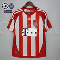 Front view of a Bayern Munich retro short-sleeve home jersey with red and white vertical stripes, white shoulder stripes, club crest and black sponsor logo.