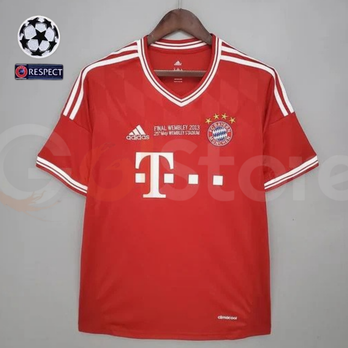 Front view of a red Bayern Munich short-sleeve jersey with white V-neck trim, white shoulder stripes, club crest and “Final Wembley 2013” chest lettering.