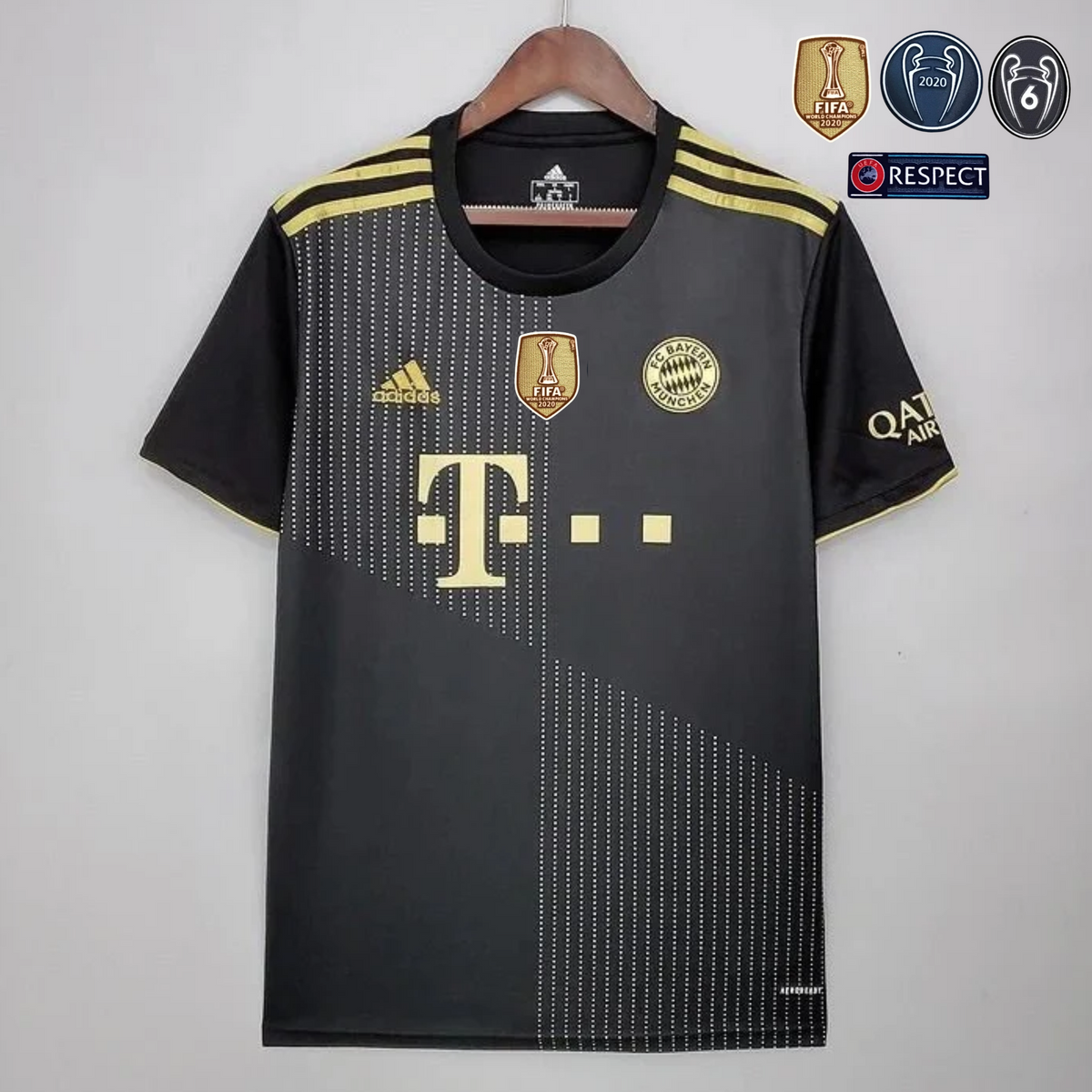 Front view of a black Bayern Munich short-sleeve away jersey with gold shoulder stripes, dotted diagonal patterns, gold club crest and sponsor logo, and a gold FIFA badge.