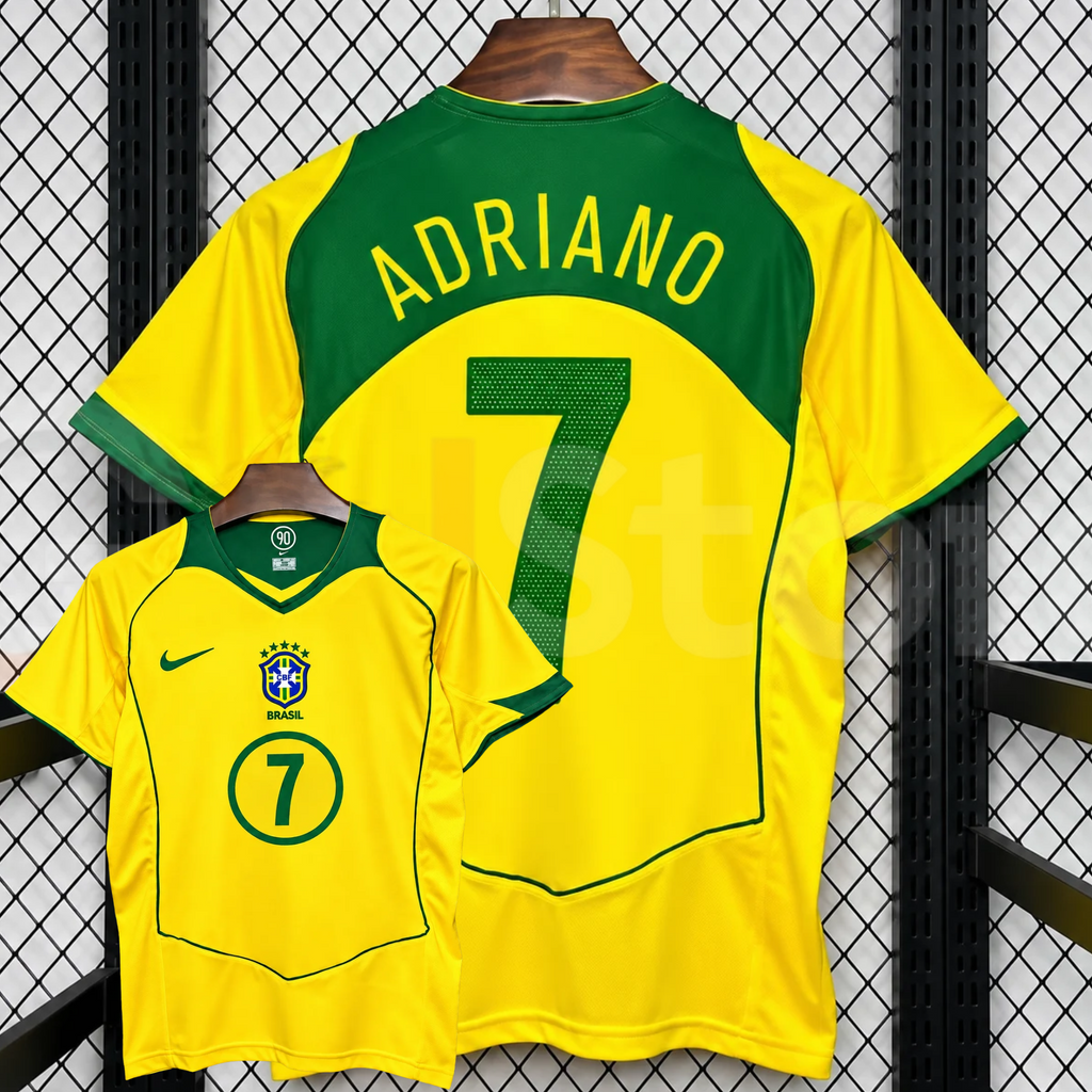 Front and back views of a yellow Brazil retro short-sleeve home jersey with green trim, yellow Adriano lettering on a green upper back panel and green number 7 print.