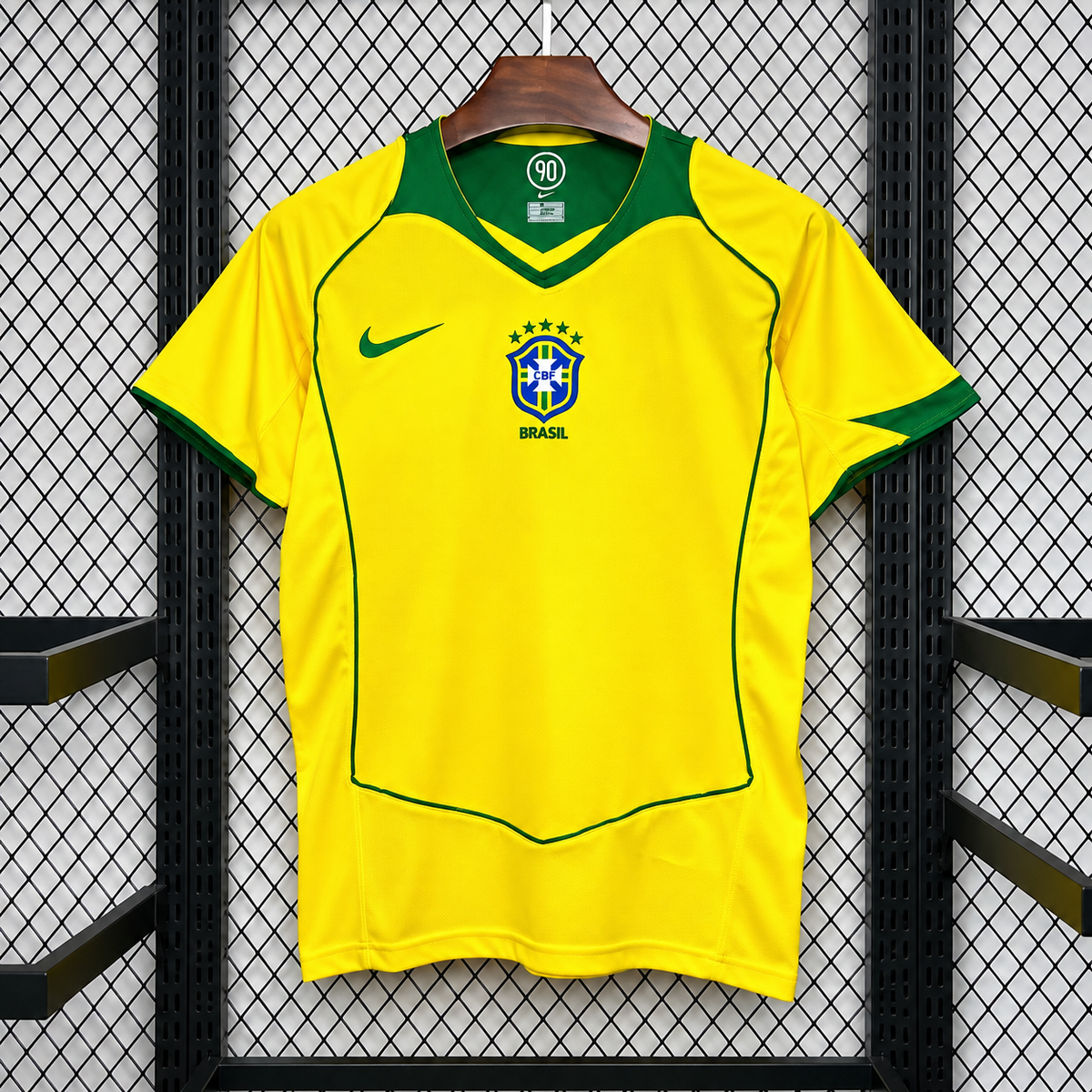 Front view of a yellow Brazil 2004 retro short-sleeve home jersey with a green V-neck, green sleeve trim and piping, and a central CBF crest.