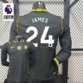 Chelsea dark grey long-sleeve jersey shown from the front and back, with white JAMES 24 print, neon yellow details and a gold FIFA World Champions chest badge.
