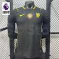 Chelsea dark grey long-sleeve jersey with neon yellow crest and Nike logo, tonal pattern and gold FIFA World Champions chest badge, alongside a Premier League graphic.

