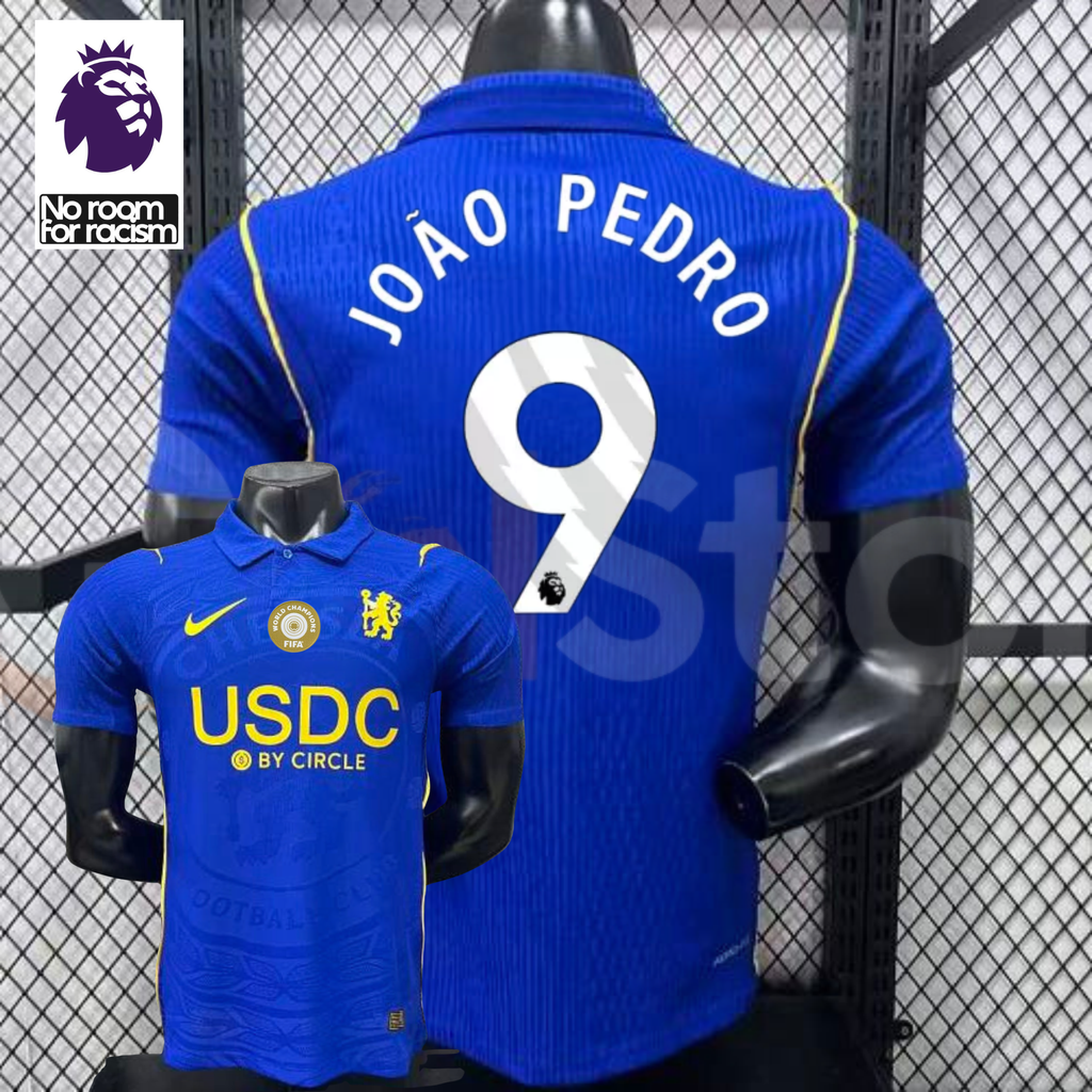 Front and back views of a blue Chelsea short-sleeve jersey with yellow details, white João Pedro number 9 print and a gold chest badge, alongside a Premier League graphic.