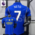 Front and back views of a blue Chelsea short-sleeve jersey with yellow details, white Neto number 7 print and a gold chest badge, alongside a Premier League graphic.