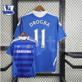 Front and back views of a blue Chelsea FC 2011–2012 retro short-sleeve home jersey with white Drogba #11 printing, tonal horizontal stripes, Chelsea crest and Samsung sponsor.