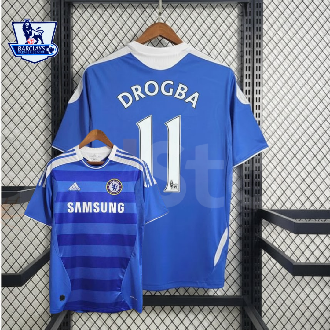 Front and back views of a blue Chelsea FC 2011–2012 retro short-sleeve home jersey with white Drogba #11 printing, tonal horizontal stripes, Chelsea crest and Samsung sponsor.