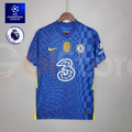 Front view of a blue Chelsea FC 2021–2022 short-sleeve home jersey with zigzag and checkerboard patterns, yellow accents, Chelsea crest, gold FIFA badge and Three sponsor.