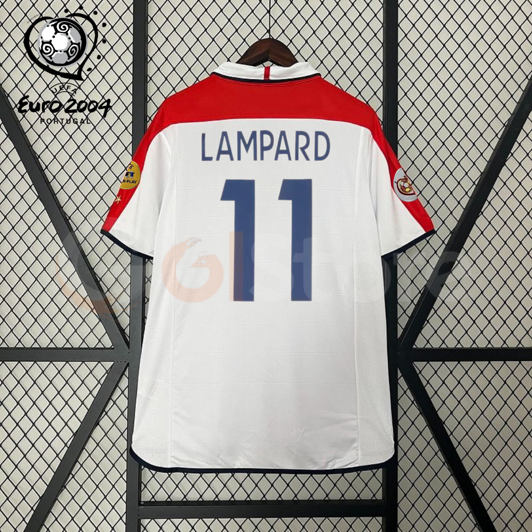 Back view of a white England short-sleeve retro jersey with red shoulder panels, dark blue Lampard number 11 print and sleeve patches, alongside a EURO 2004 graphic.