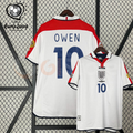 Front and back views of a white England short-sleeve retro jersey with red shoulder panels, dark blue Owen number 10 print and sleeve patches, alongside a EURO 2004 graphic.