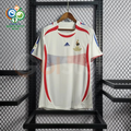 Front view of a France 2006 retro white short-sleeve away jersey with red and blue detailing, national team crest and a World Cup sleeve patch.
