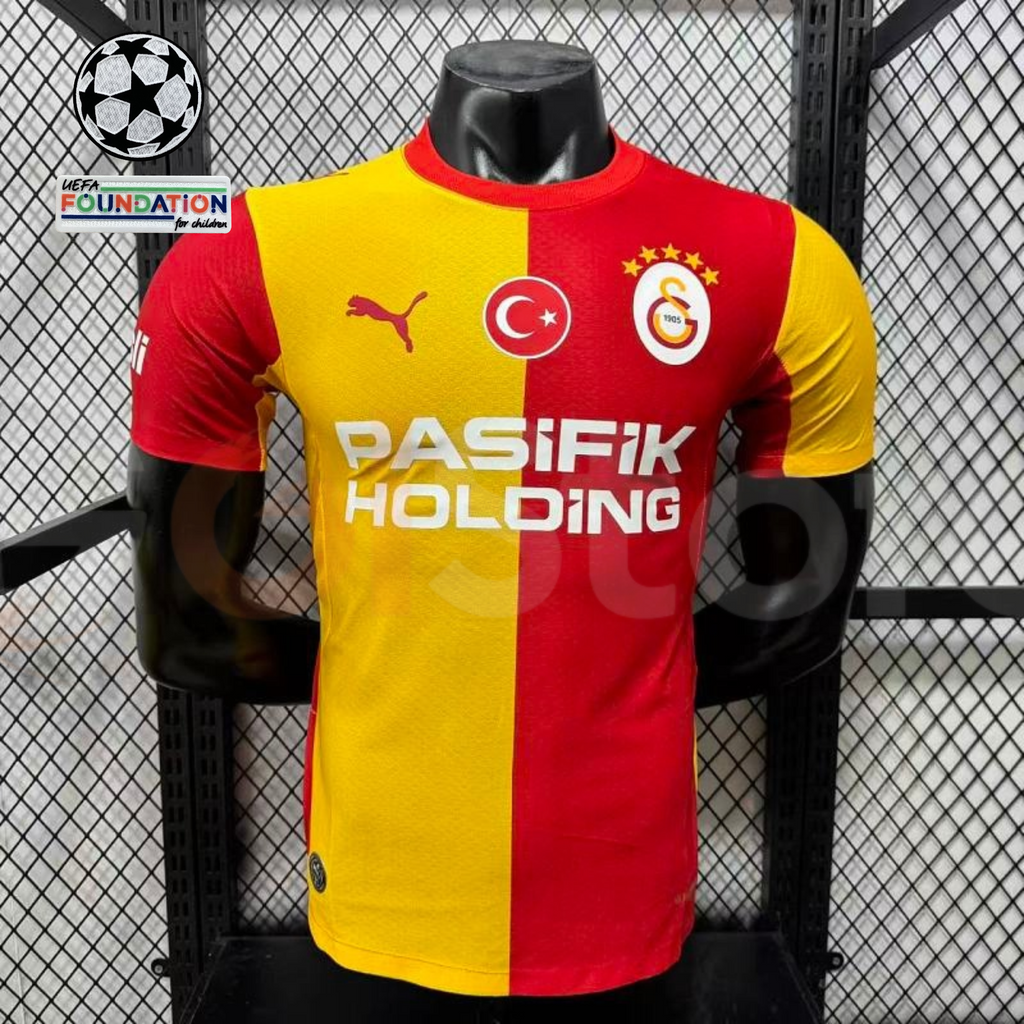 Front view of a red and yellow Galatasaray short-sleeve home jersey with the club crest, Turkish flag emblem and white Pasifik Holding sponsor.