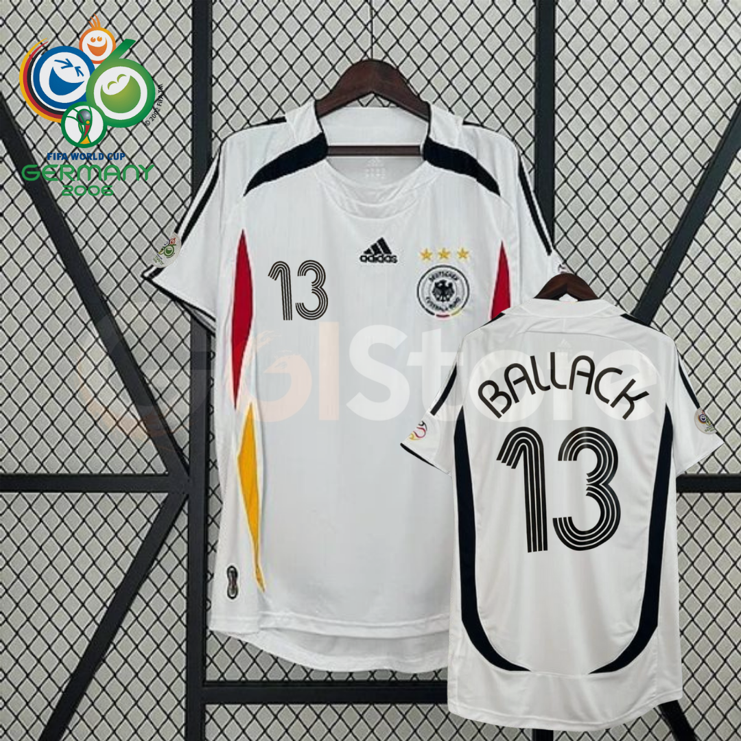 Front and back views of a white Germany 2006 retro short-sleeve home jersey with black, red and gold details, Ballack number 13 print and World Cup sleeve patches.