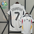 Front and back views of a white Germany 2006 retro short-sleeve home jersey with black, red and gold details, Schweinsteiger number 7 print and World Cup sleeve patches.