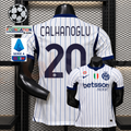 Front and back views of a white Inter Milan short-sleeve jersey with blue pinstripes, navy Çalhanoğlu number 20 print and Betsson Sport sponsor, alongside UCL and Serie A graphics.
