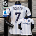 Front and back views of a white Inter Milan short-sleeve jersey with thin blue pinstripes, navy Zielinski number 7 print and Betsson Sport sponsor, alongside UCL and Serie A graphics.