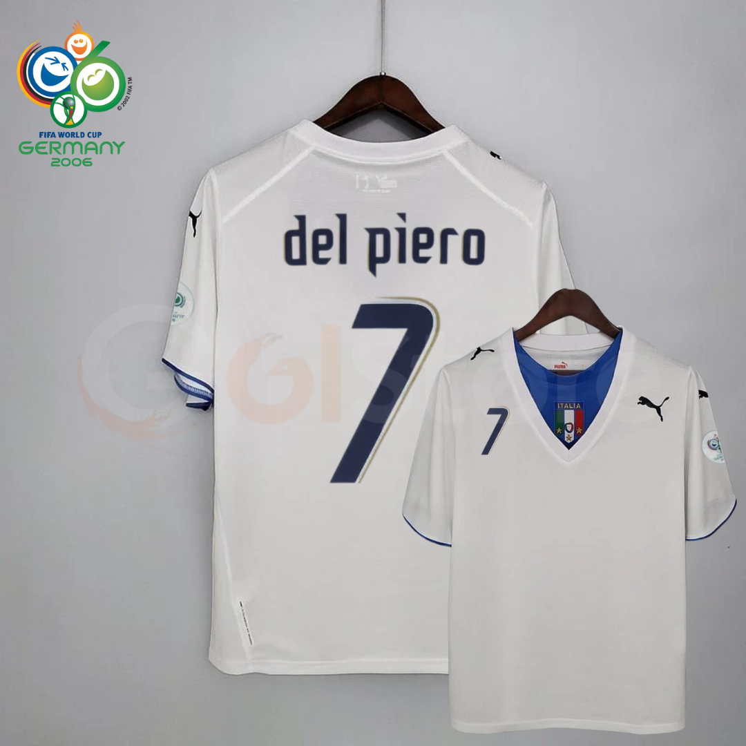 Front and back views of a white Italy short-sleeve retro away jersey with a blue neckline panel, dark Del Piero number 7 print and sleeve patches, alongside a Germany 2006 World Cup graphic.