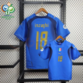 Front and back views of a blue Italy short-sleeve retro home jersey with dark panels, gold Inzaghi number 18 print and sleeve patches, alongside a Germany 2006 World Cup graphic.