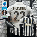 Juventus black and white short-sleeve jersey, front and back views with MCKENNIE 22 print, white polo collar and gold Jeep detailing.
