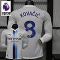  Back view of a white Manchester City long-sleeve jersey with blue Kovačić name and number 8 print, featuring a Premier League lion on the number, alongside a Premier League graphic.