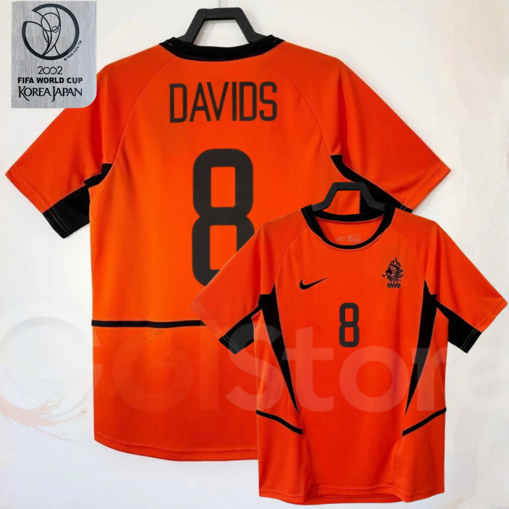 Netherlands orange short-sleeve retro jersey, front and back views with DAVIDS 8 print, black collar and side panels, alongside a 2002 World Cup graphic.
