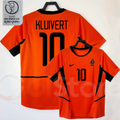 Netherlands orange short-sleeve retro jersey, front and back views with KLUIVERT 10 print, black collar and side panels, alongside a 2002 World Cup graphic.
