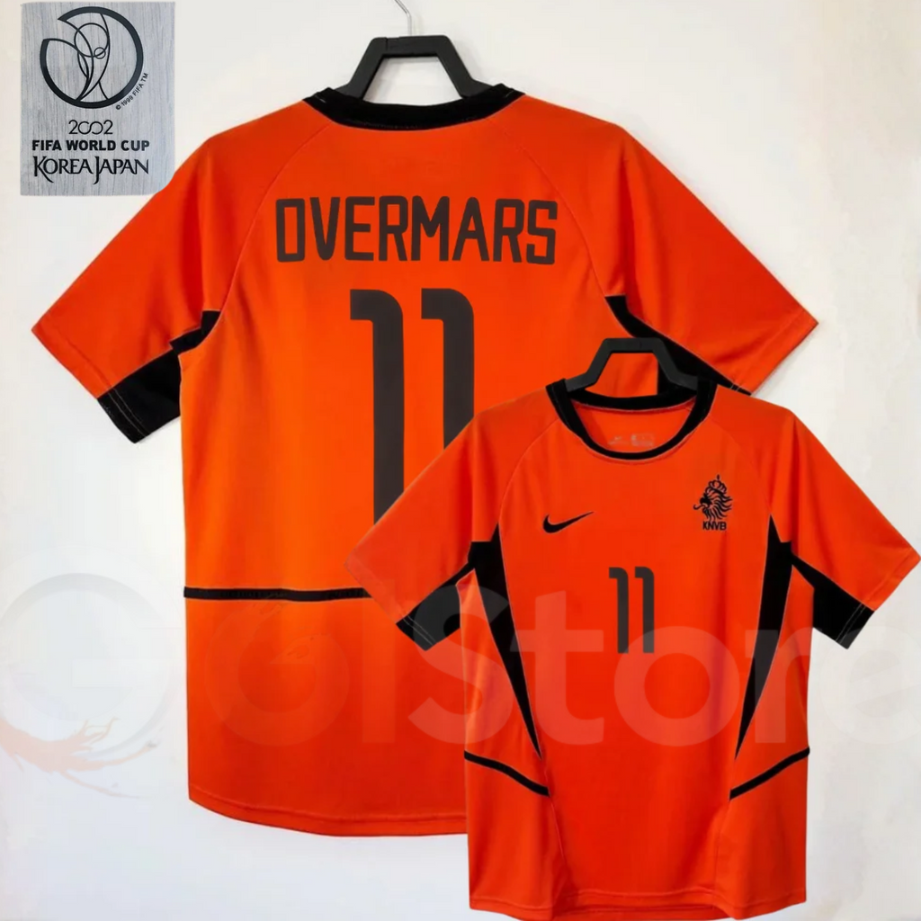Netherlands orange short-sleeve retro jersey, front and back views with OVERMARS 11 print, black collar and side panels, alongside a 2002 World Cup graphic.
