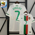 Front and back views of a white Portugal 2010 retro short-sleeve away jersey with green Ronaldo #7 printing, green and red front panels and World Cup sleeve patches.