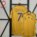 Front and back views of a yellow Spain 2008 short-sleeve away jersey with blue David Villa #7 printing, black shoulder stripes and Euro 2008 sleeve patch.