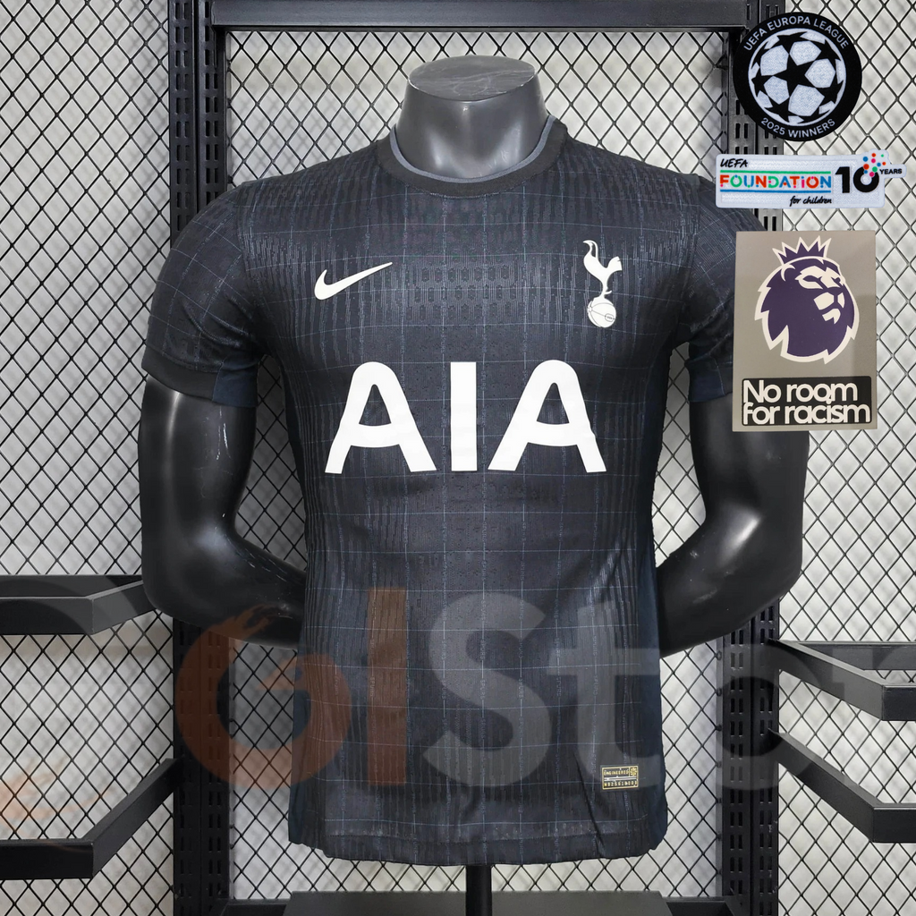 Front view of a black Tottenham Hotspur short-sleeve jersey with a subtle grid pattern, white club crest and white AIA sponsor.