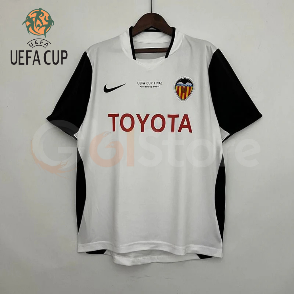 Front view of a white Valencia CF retro short-sleeve jersey with black sleeves, red Toyota sponsor and UEFA Cup Final Göteborg 2004 chest lettering.